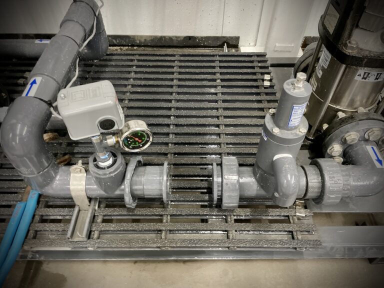 Hydroponic system maintenance example showing a check valve and instrumentation at a packaged pumping system